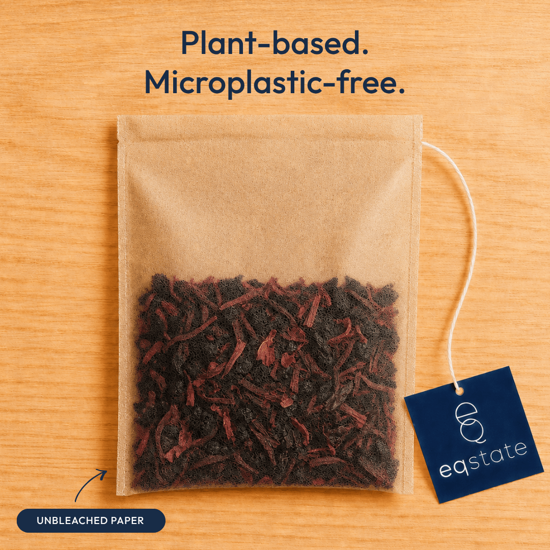Tea bag with a tea blend on a wooden surface, featuring 'eqstate' branding.